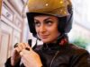 A woman wearing a moto helmet.