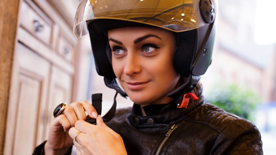 A woman wearing a moto helmet.